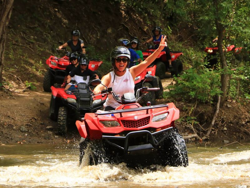 ATV quads crossing a jungle river near Santa Teresa, Costa Rica