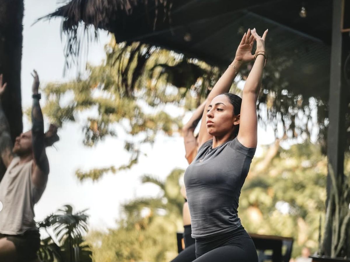 Group yoga class on the wooden deck during a retreat at Bohemia Experience, Santa Teresa